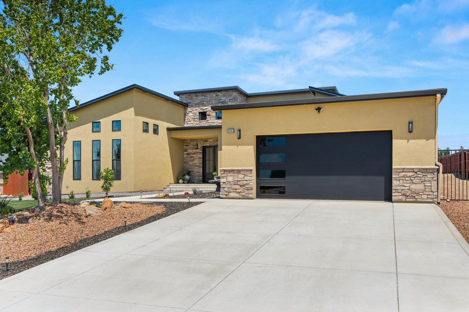 Front elevation showing garage and stone accents